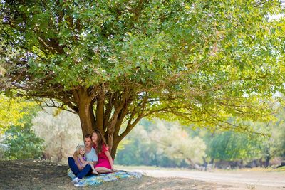 Low section of woman walking on tree