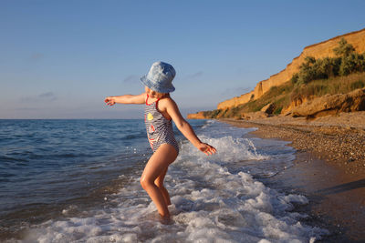 Full length of woman on beach against sky