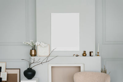 Stylish minimalist scandinavian living room decor in gray. mockup of a painting over the fireplace