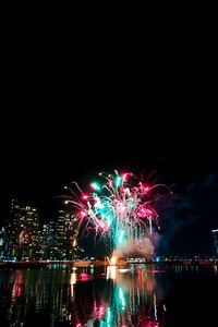 Firework display over city at night