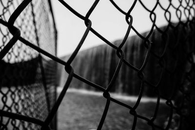 Close-up of chainlink fence against sky