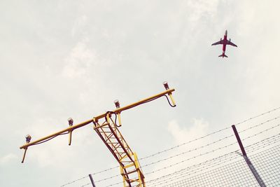 Low angle view of crane against sky