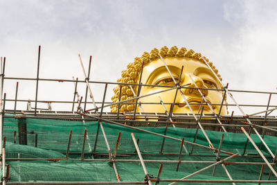 The head of the big golden buddha statue is under construction, in wat paknam bhasicharoen.
