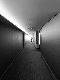 Man walking in corridor of building