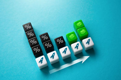 High angle view of dices on blue background