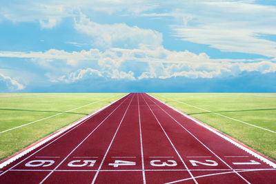 Running track amidst landscape against sky