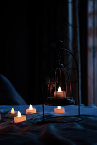 Close-up of illuminated lamp on table