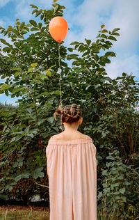 Rear view of a girl standing with balloon