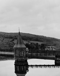 View of bridge over river against cloudy sky