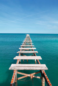 Path to the sea with broken planks . old wooden pier . way to nowhere