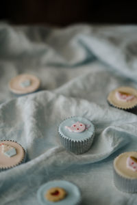 High angle view of cupcakes on fabric