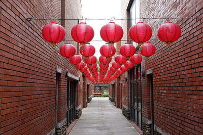 Red lanterns hanging on wall in building