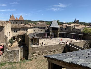 Group of people in old building against sky