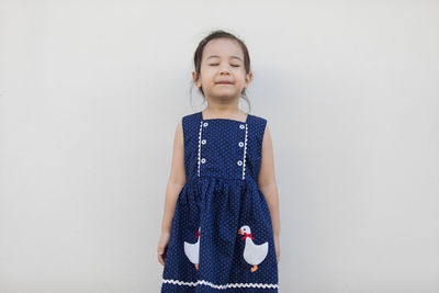 Happy girl standing against white background