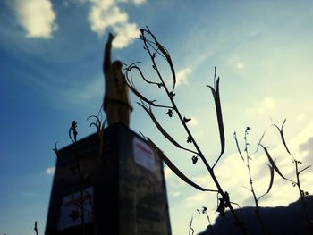 Low angle view of cross on building against sky