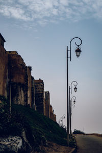 Low angle view of street light against building