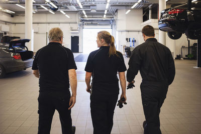 Rear view of people walking in corridor