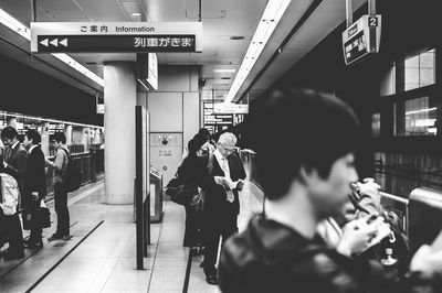 People walking on railroad station platform