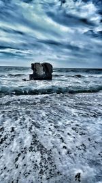 Scenic view of sea against cloudy sky