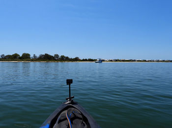 Scenic view of lake against clear blue sky