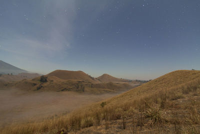 Scenic view of arid landscape against sky