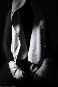 Close-up of hands against black background