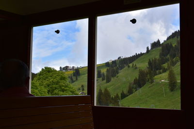 Scenic view of landscape seen through window