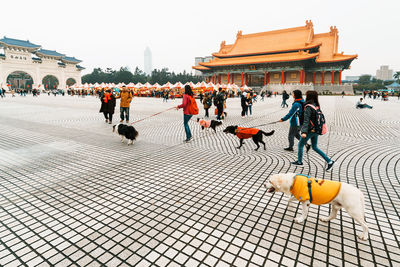 Group of people walking in front of building