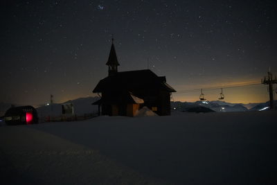 Traditional building against sky at night