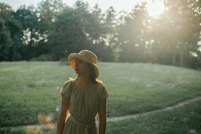 Beautiful woman looking away standing in park