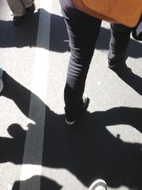 Low section of woman standing on tiled floor