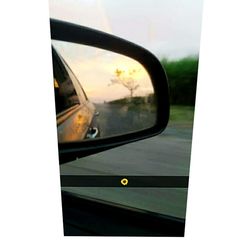 Reflection of car on side-view mirror