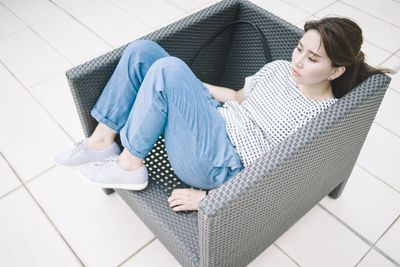 Rear view of man sitting on bench