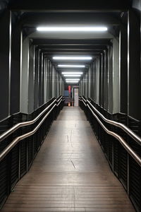 Rear view of man walking in illuminated building