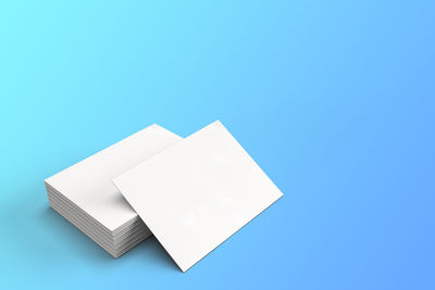 Close-up of white paper against blue background