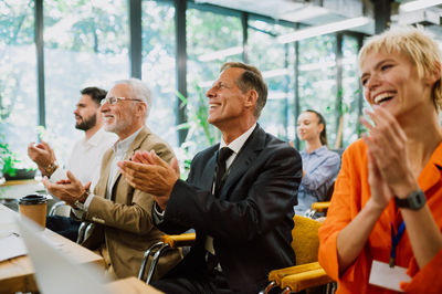 Business colleagues stacking hands in office