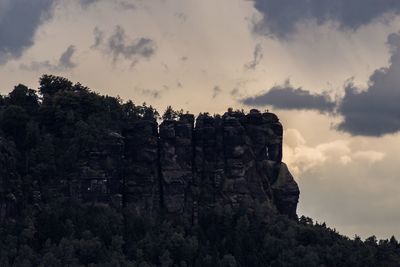 Low angle view of cliff against sky