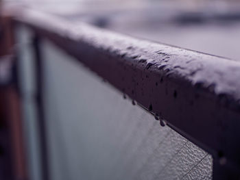 Close-up of old pipe on railing