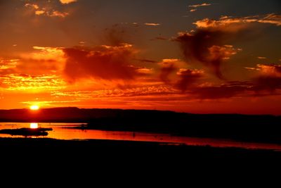 Scenic view of dramatic sky over sea during sunset