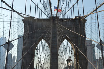 Low angle view of brooklyn bridge against sky in new york city.