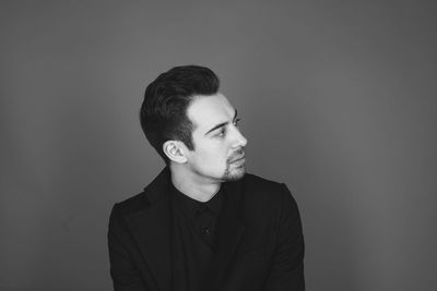 Portrait of young man against white background