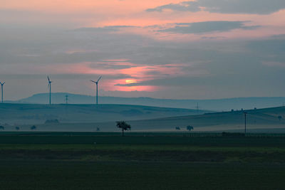 Scenic view of field against sky during sunset