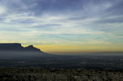 Scenic view of mountains against cloudy sky