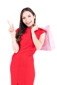 Portrait of a smiling young woman against white background