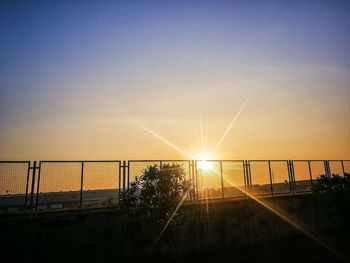 Silhouette bridge against sky during sunset