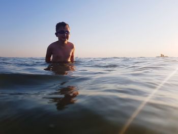 Portrait of shirtless man in swimming pool