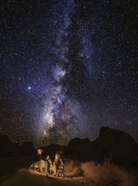 Low angle view of silhouette trees against sky at night