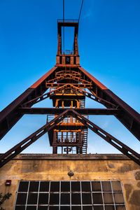 Low angle view of built structure against clear blue sky