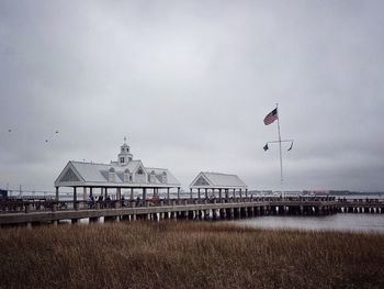 Mount pleasant pier amidst river against sky