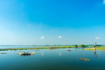 Scenic view of sea against blue sky